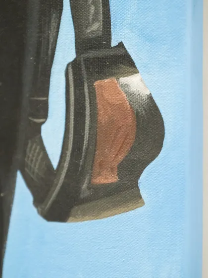 A detail of the ski goggles held by Mona Lisa, a modern accessory that completes her transformation into a contemporary icon.