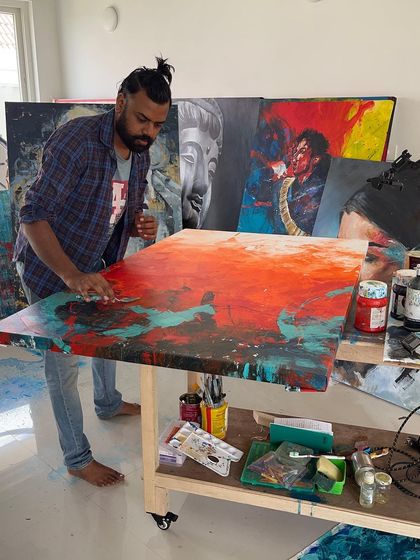 Back in the studio, deep in the process of creating. You can see the array of paints and tools I use to bring my visions to life.