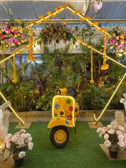 Our iconic yellow scooter decorated with flowers, serving as a quirky and fun photo prop for a Haldi or Mehendi event.