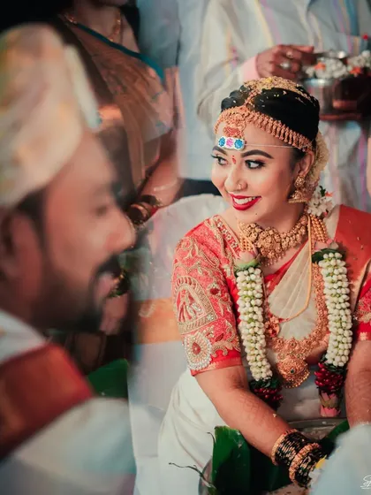 A glance between the couple during the ceremony. We use creative techniques like reflections to capture these fleeting, intimate exchanges that tell the real story of your wedding day.