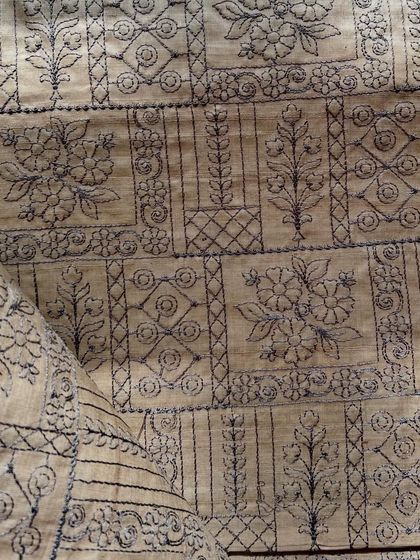A full view of our embroidered Tussar silk, showcasing the beautiful arrangement of floral and geometric patterns. This fabric has a wonderful structure for tailored garments.
