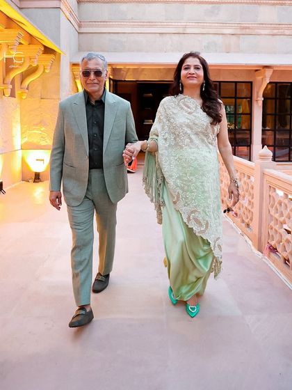 Suit up and own the moment. This client wears a custom sage green suit, proving that tailored elegance comes in many colors and is perfect for any celebration.