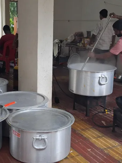This is a glimpse of our kitchen during preparation for a large Bhandara. We use large pots to cook fresh food on-site, ensuring everything is hot and tasty for your guests.