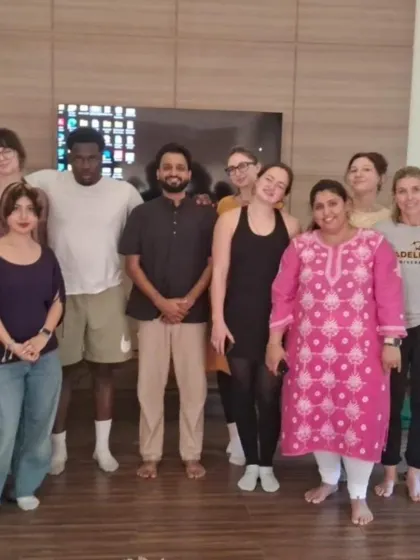 A group of international students from Adelphi University pose with our instructors. We are proud to be a global destination for authentic yoga education, sharing our lineage with seekers from around the world.