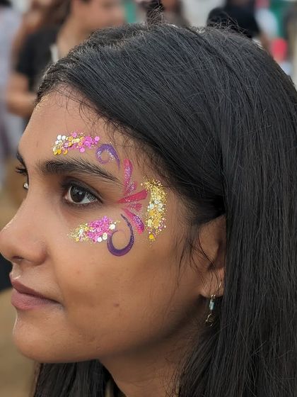 A beautiful abstract butterfly design created with pink and purple paint and accented with gold and pink glitter.