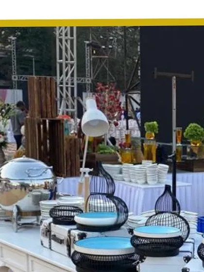 A wide view of one of our buffet stations, showcasing a clean and organized layout with modern decor elements like geometric-patterned bowls and a large floor lamp.