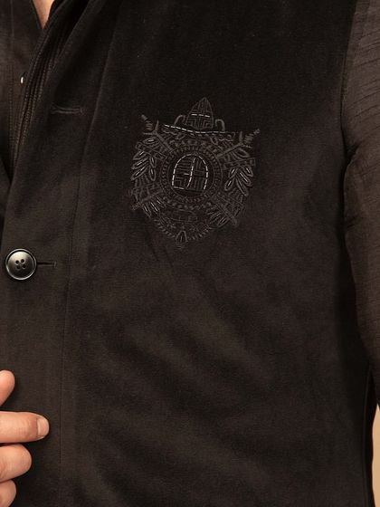 A close-up of the embroidered motif on the black velvet Nehru jacket. This detail adds a layer of sophistication and personality to the garment, showcasing my commitment to fine craftsmanship.