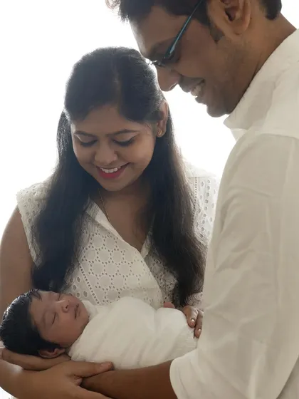 A color version of the classic newborn family portrait. The parents' loving gaze and the baby's peaceful sleep are the heart of this image.