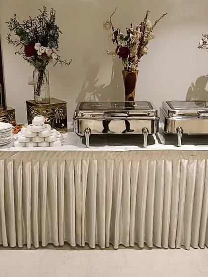 A compact and elegant catering setup for a small gathering of 25 guests. The beautiful decor and premium chafing dishes show that no event is too small for a gourmet touch.