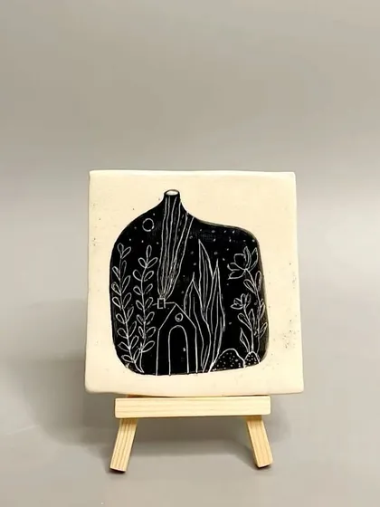This square tile features a whimsical scene of a house at night, carved using the sgraffito technique. It's a perfect little piece of art for a side table or shelf.