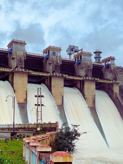 The Harangi Dam with its gates open during the monsoon season, a powerful and spectacular sight.