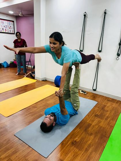 I act as the base for a student in a therapeutic flying pose. This type of Acro Yoga is deeply relaxing for the flyer and builds strength for the base.