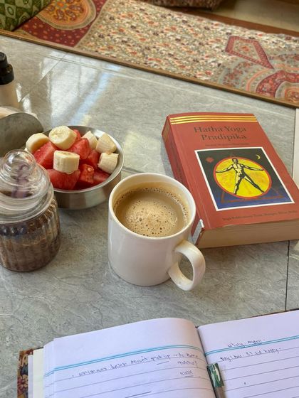My study corner in Mysore, with my journal, the Hatha Yoga Pradipika, and a cup of coffee. Self-study (Svadhyaya) is a key part of my path.