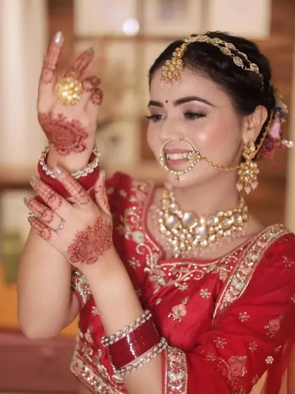 A candid shot of the bride admiring her mehendi, capturing a natural and joyful moment during her wedding day preparations.