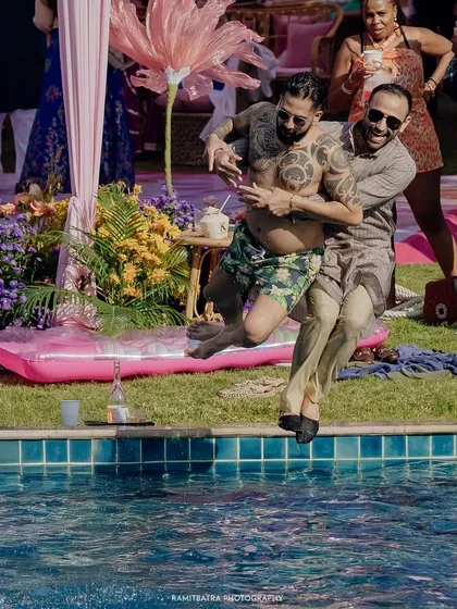 More pool party madness as guests take a joyful leap into the water during the destination wedding festivities.