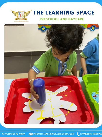 A child uses a dropper to add color to their Holi craft. This requires precision and focus, making it an excellent fine motor skill practice.