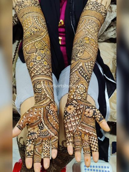 A full view of this elaborate floral and paisley mehendi. Every part of the hand and arm is covered in detailed artwork, perfect for a bride or for a grand celebration.
