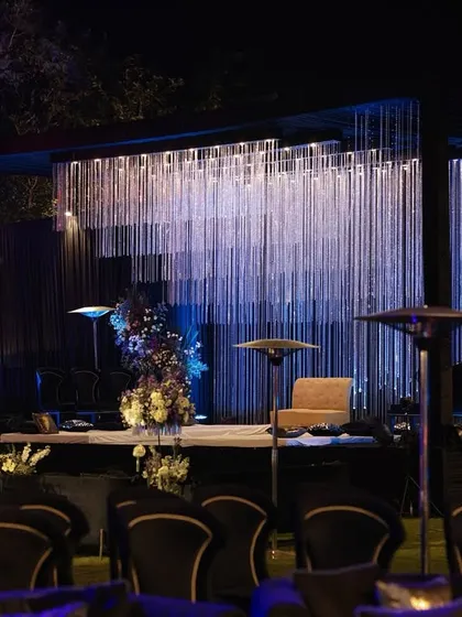 Another perspective of the crystal cascade stage, showing how it commands attention in the outdoor setting, complemented by elegant black velvet chairs for the audience.
