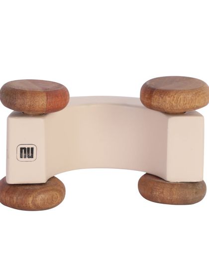 The bottom of a white wooden toy car, showing the brand mark.