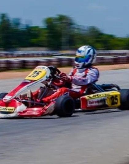 A panning shot captures the speed of our driver in kart number 25 during a sunny day on the track.