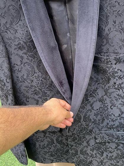 For the finale of Bigg Boss 16, I chose a black jacquard fabric for Salman Khan's jacket. This close-up shows the intricate texture and the velvet lapel, details that make an outfit stand out.