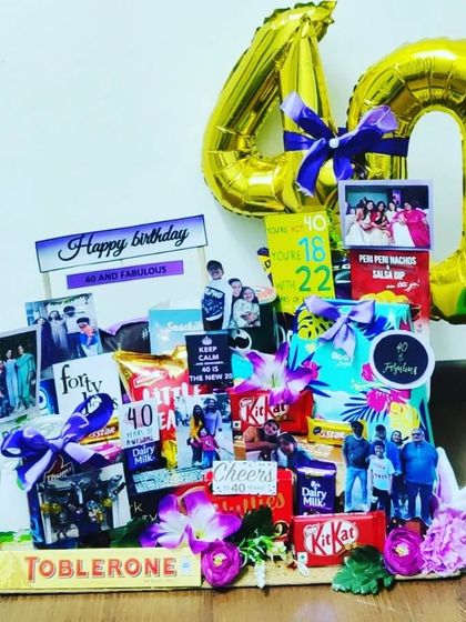 Another take on the '40 and Fabulous' theme, this hamper is bursting with color and treats. It includes a large foil '40' balloon, personal photos, and a variety of chocolates and snacks.