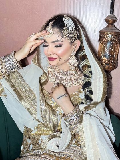 A close-up of the white and gold Walima look, showing the detailed eye makeup and tattoo.