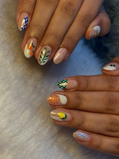 This mismatched manicure is full of personality. We combined different patterns like checkerboards, stripes, and florals in a cohesive color palette for a fun and artistic look.