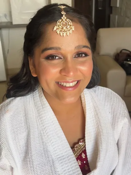 A happy and smiling close-up. The makeup is fresh and youthful, enhancing her natural features and beautiful smile.