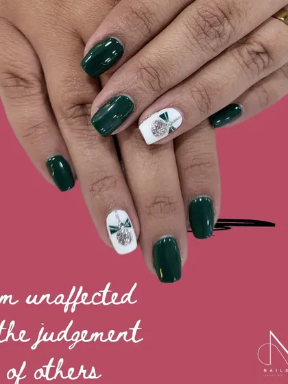 "I am unaffected by the judgement of others." This chic dark green manicure with a white and silver bow accent is for the confident individual.