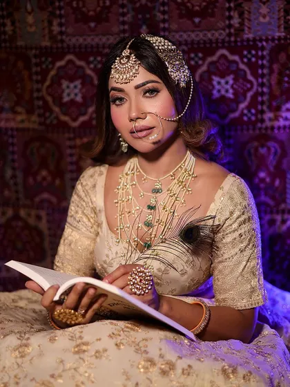 The model posing with a book in the Heeramandi-inspired look, adding a touch of storytelling and artistry to the portrait.