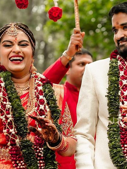 A candid shot of the bride and groom laughing during their wedding procession, a moment of pure happiness.