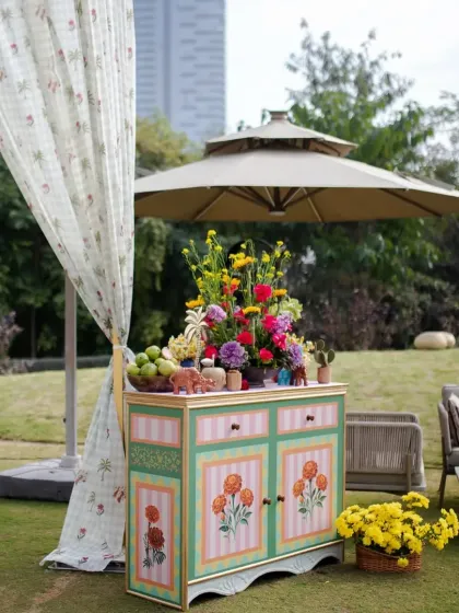 We believe every corner should be a photo opportunity. This hand-painted cabinet, overflowing with fresh flowers and fruit, served as a beautiful and functional decor piece for the outdoor celebration.