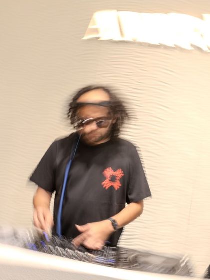 A motion-blur photo capturing the energy of my set at the Amiri store launch. Even in a retail environment, I bring a dynamic presence.