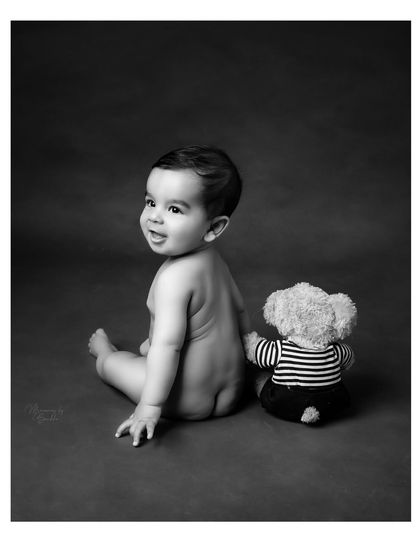 Sitting up, rolling over, and full of giggles. This simple, classic black and white portrait of a 6-month-old with his teddy bear captures the joy of this unforgettable phase.