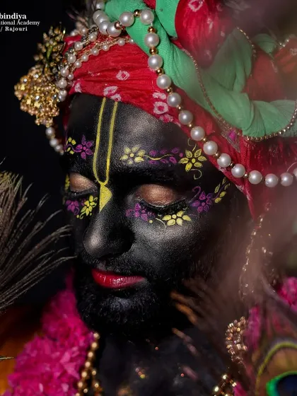 A close-up of the Krishna makeup, showing the detailed face painting and the serene expression created through the art of makeup.