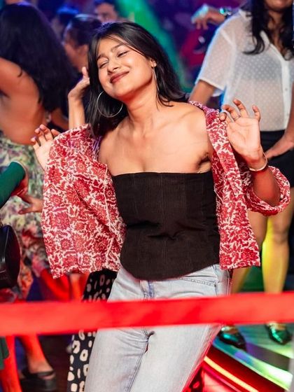 A stylish partygoer enjoying the vibe at Big Pitcher.