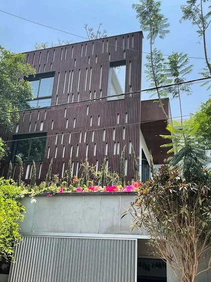 The unique slatted facade of this home in Koramangala provides privacy and sun shading while creating a visually dynamic exterior that changes with the light.