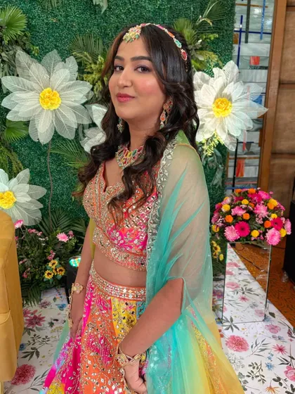 A pop of color for a Sangeet night! This bride's multi-colored lehenga is paired with soft, radiant makeup for a fun and festive look.