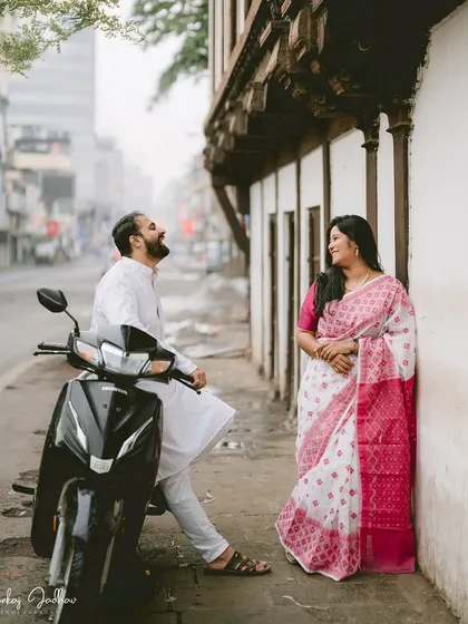 Laughter on a city street. This candid moment with a scooter adds a touch of modern life and fun to Chaitrali and Parth's pre-wedding shoot in the old city of Pune.