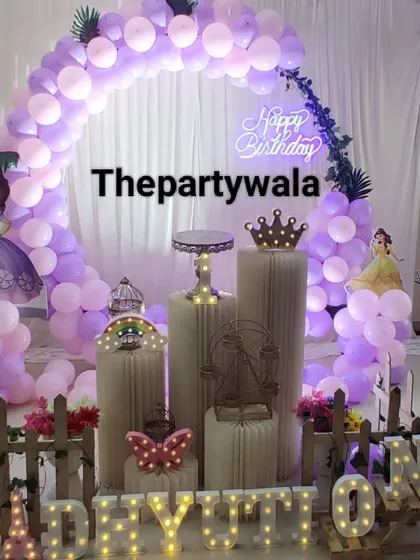 Another take on the Princess Sofia theme, this time with a mix of purple and peach balloons. The "Happy Birthday" neon sign adds a modern touch to the classic fairy tale look.