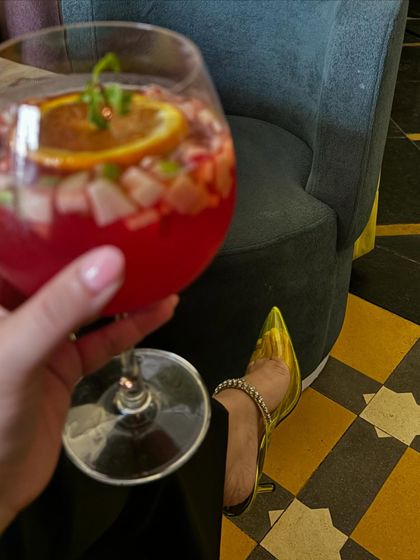 A close-up of my sangria and my stylish heels.