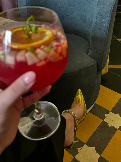 A close-up of my sangria and my stylish heels.
