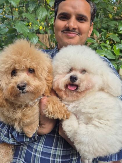 A happy, smiling trio. Narain with Archie and Columbus, showcasing the joyful and positive atmosphere our team cultivates every day.