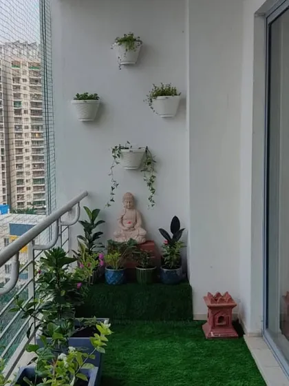 A wider perspective of the completed balcony garden, showing the balance between the planted areas, the seating space, and the open view.