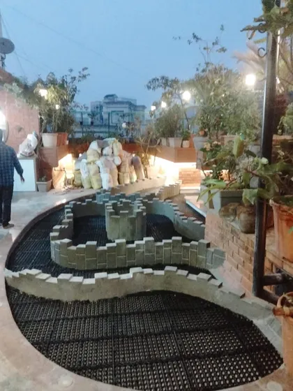 An evening view of a terrace project in progress. The layout of the drain cells and planter walls is clearly visible, mapping out the future garden and walkways.