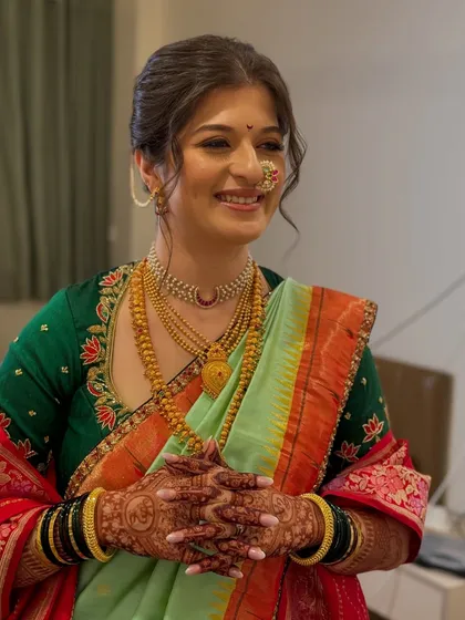 A portrait of the radiant Maharashtrian bride, her traditional hairstyle completing her look.