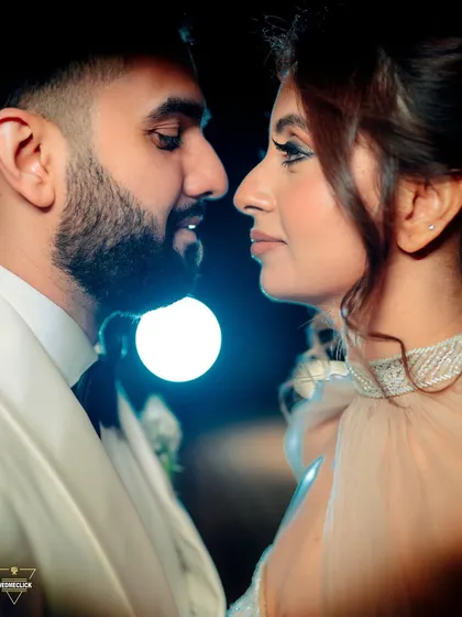 A close-up, intimate portrait of the couple, the soft lighting and their proximity creating a very romantic and personal feel.