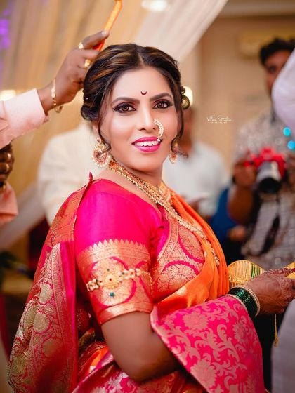 A candid moment during the ceremony as a final touch is made to the bride's hair. Her bright smile shows she is enjoying every moment of her special day. (Duplicate of 85)