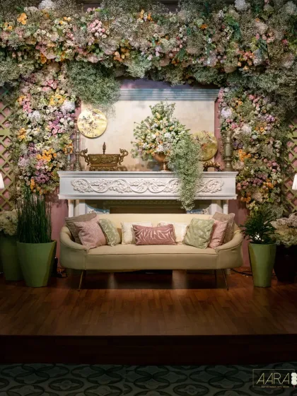 'Whispers of Spring' is a concept inspired by the delicate grace of Chinese porcelain gardens. This photo booth features a lush floral frame and an ornate fireplace, blending pastel florals with chinoiserie motifs for a touch of timeless luxury.